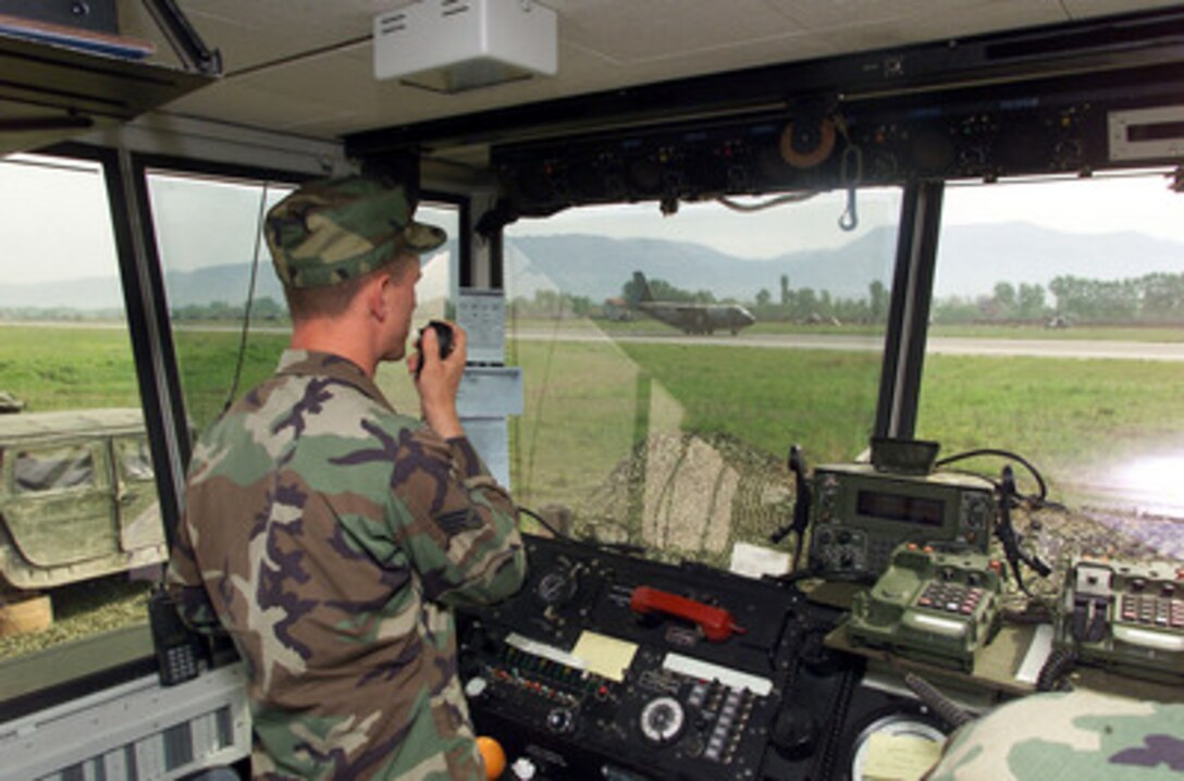 U.S. Air Force Senior Airman Darren Hooper directs an aircraft landing at Rinas Airport, Tiranë, Albania, during NATO Operation Allied Force on April 29, 1999. Operation Allied Force is the air operation against targets in the Federal Republic of Yugoslavia. U.S. Army and Air Force controllers have taken over the air traffic control mission at the airport often handling hundreds of military and civilian aircraft daily. Hooper is an air traffic controller from the 1st Operations Support Squadron, Langley Air Force Base, Va. 