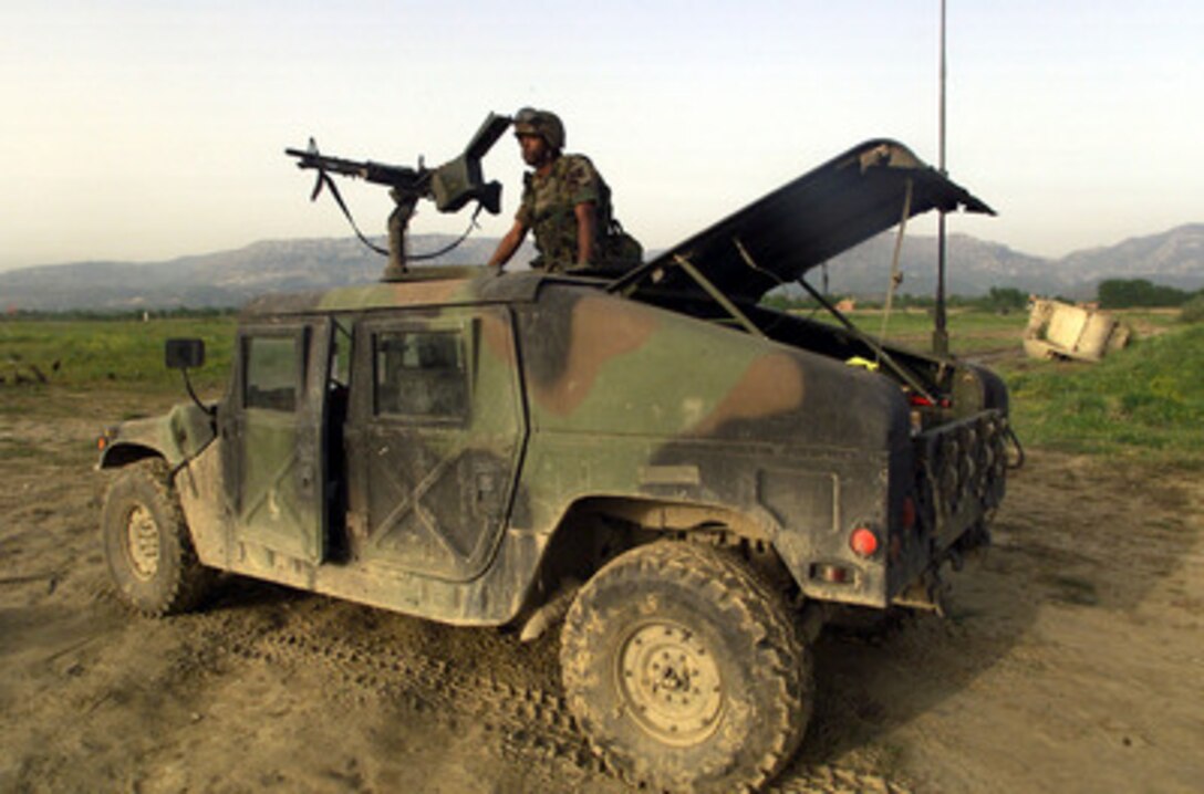 Air Force security specialist Airman John Berry watches the perimeter during guard duty at Rinas Airport in Tiranë, Albania, during NATO Operation Allied Force on April 29, 1999. Operation Allied Force is the air operation against targets in the Federal Republic of Yugoslavia. Air Force security personnel are providing airfield security for incoming aircraft and personnel deployed to the airport in support of Task Force Hawk and Joint Task Force Shining Hope. Berry is attached to the 568th Security Forces Squadron at Ramstein Air Base, Germany. 