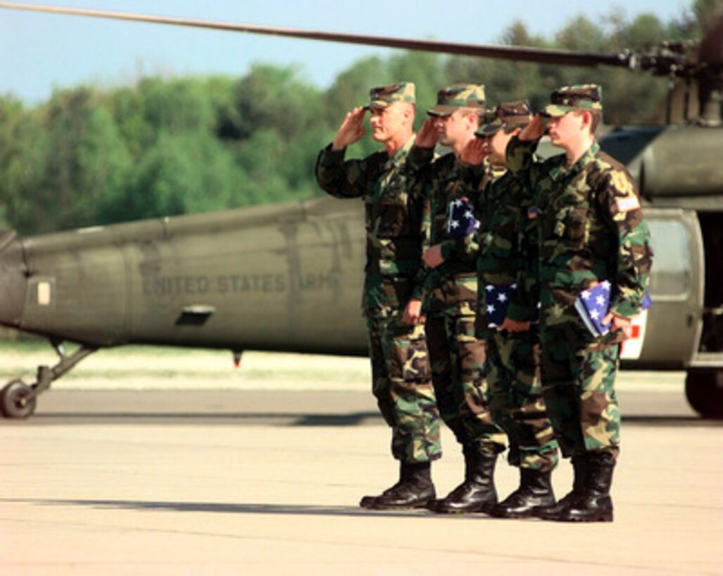 Staff Sgts. Chris Stone and Andrew Ramirez, Specialist Steven Gonzales and their escort salute the colors on their return to Ramstein Air Base, Germany, on May 2, 1999. Stone, Ramirez and Gonzales are the three soldiers from the U.S. Army's 1st Infantry Division who were captured by Yugoslavian forces during NATO Operation Allied Force. 