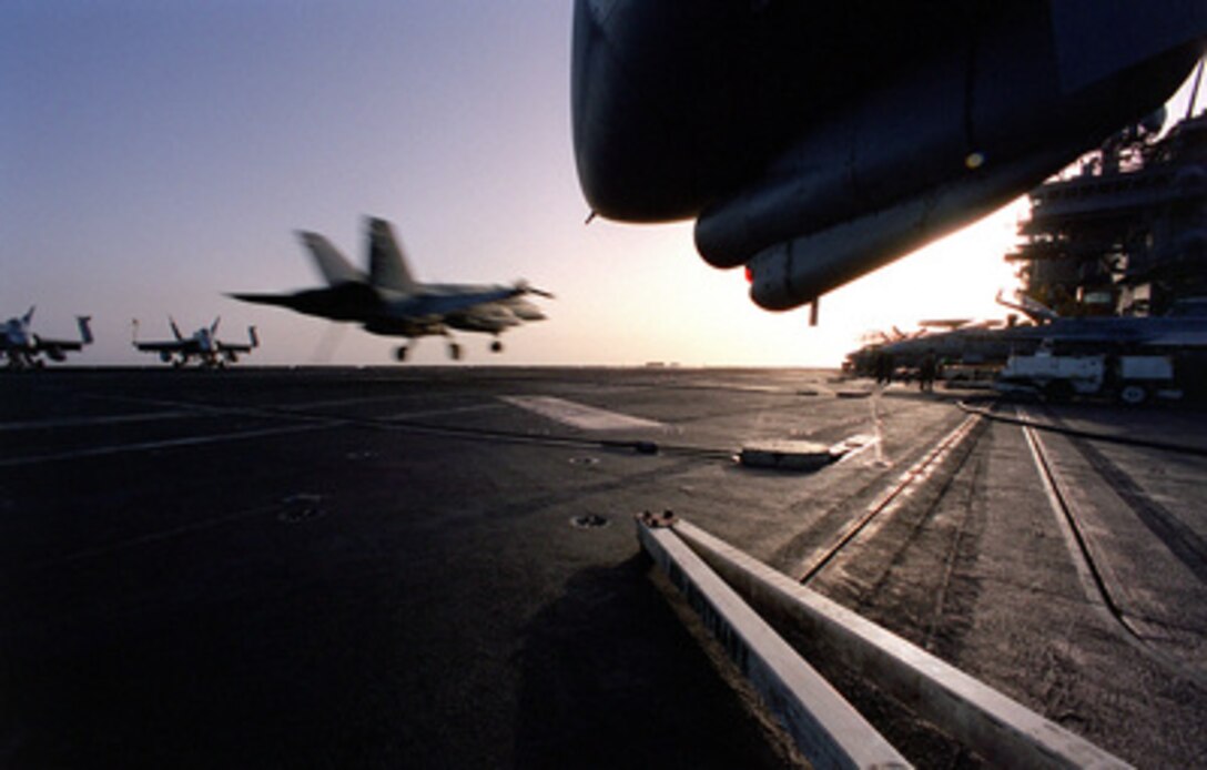 An F/A-18 Hornet comes in for an arrested landing on the flight deck of the USS Kitty Hawk (CV 63) on May 4, 1999, after completing a mission in support of Operation Southern Watch. Kitty Hawk and its embarked Carrier Air Wing 5 are on station in the Persian Gulf in support of Operation Southern Watch which is the U.S. and coalition enforcement of the no-fly-zone over Southern Iraq. 