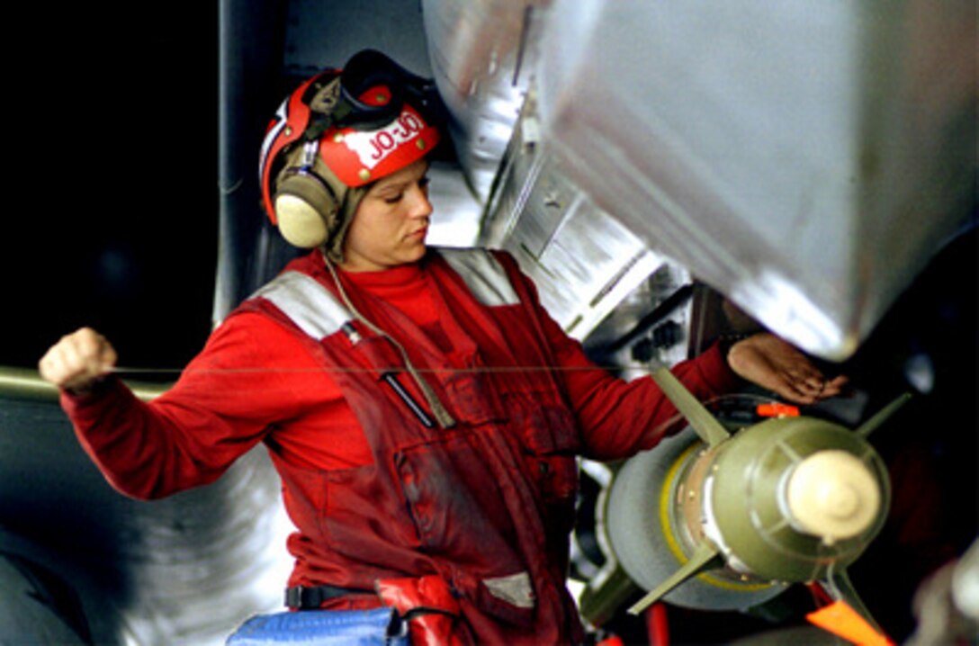 A U.S. Navy aviation ordnanceman applies the final wiring to a GBU-24 laser-guided bomb attached to an F-14 Tomcat on the flight deck of the USS Theodore Roosevelt (CVN 71) on May 4, 1999. Roosevelt and its embarked Carrier Air Wing 8 are operating in the Adriatic Sea in support of NATO Operation Allied Force which is the air operation against targets in the Federal Republic of Yugoslavia. 