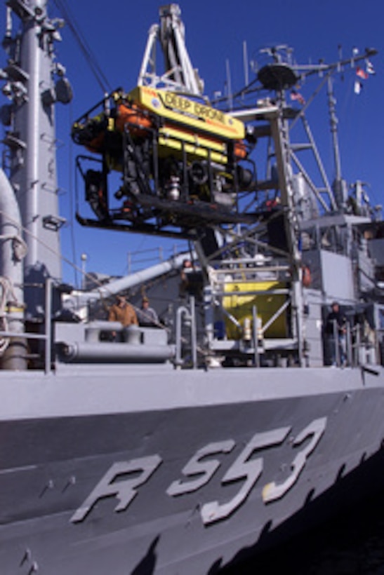 Crew members of the USS Grapple (ARS 53) lower the Deep Diving Submersible Drone into the water at Naval Station Newport, R.I., on Nov. 4, 1999, for a wet check in preparation for EgyptAir Flight 990 recovery operations off the coast of Nantucket, Mass. The auxiliary rescue salvage ship was involved in the search and recovery of TWA Flight 800. 