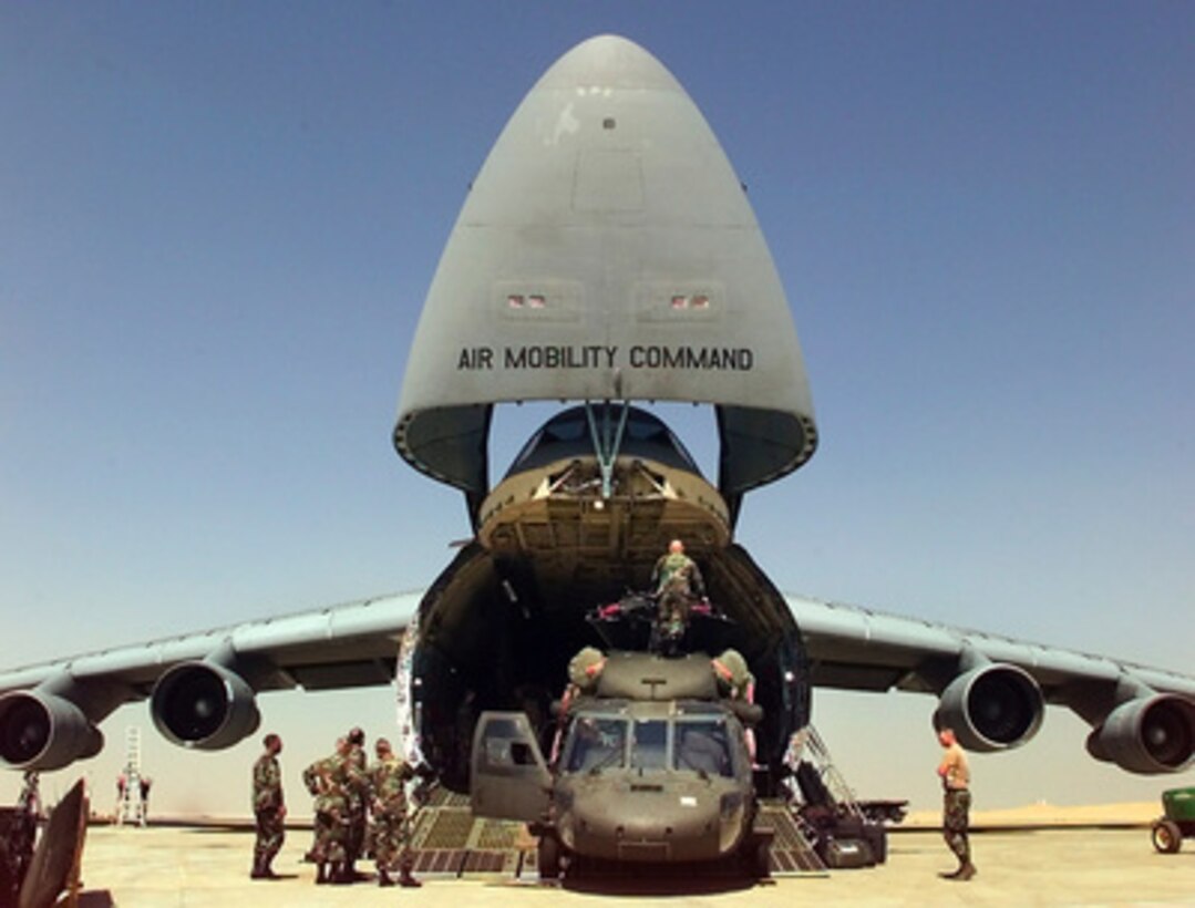 U.S. Army personnel unload their UH-60L Black Hawk helicopters from a U.S. Air Force C-5 Galaxy at Cairo West Air Base, Egypt, for Exercise Bright Star '99/00 on Oct. 2, 1999. Bright Star is a joint/combined command post and tactical field exercise in Egypt involving over 50,000 participants from 11 countries. The annual exercise is designed to improve readiness and interoperability between U.S., Egyptian and coalition forces. 