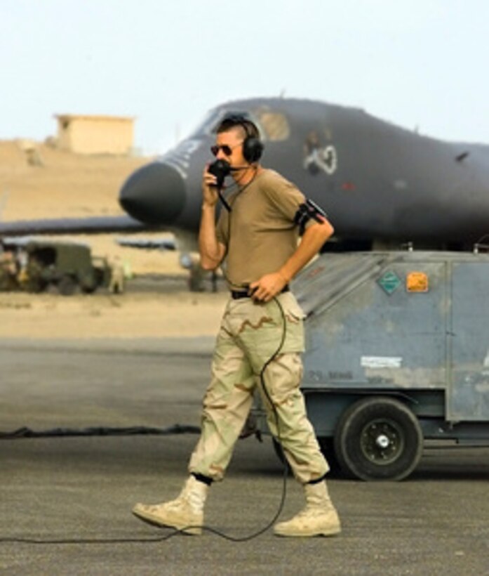 A U.S. Air Force B-1B Lancer bomber crew chief talks to the air crew in the plane on the flight line at Cairo West Air Base, Egypt, during Exercise Bright Star '99/00 on Oct. 15, 1999. Bright Star is a joint/combined command post and tactical field exercise in Egypt involving over 50,000 participants from 11 countries. The annual exercise is designed to improve readiness and interoperability between U.S., Egyptian and coalition forces. The Lancer and crew are deployed from the 28th Bomb Wing, Ellsworth Air Force Base, S.D. 