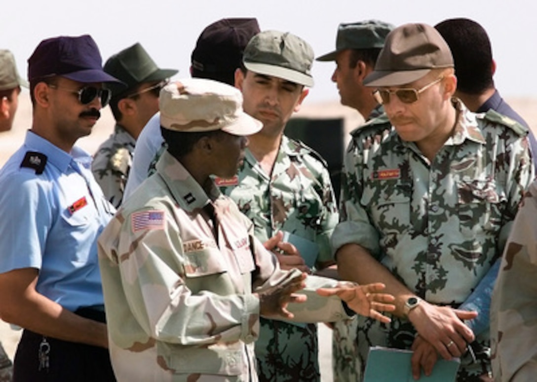 Capt. Erika Dance-Walker (center), U.S. Army, explains the Patriot Missile system to coalition military members during the Exercise Bright Star '99/00 static display day at Cairo West Air Base, Egypt, on Oct. 18, 1999. Bright Star is a joint/combined command post and tactical field exercise in Egypt involving over 50,000 participants from 11 countries. The annual exercise is designed to improve readiness and interoperability between U.S., Egyptian and coalition forces. Dance-Walker is deployed for the exercise from Bravo 2-43 Battery, Air Defense Artillery, Fort Bliss, Texas. 