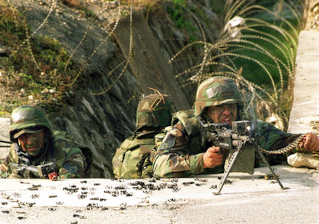 Members of the 434th Security Forces Squadron defend Osan Air Base, Korea, during a simulated attack by opposition forces on Oct. 25, 1999, as part of Exercise Foal Eagle '99. Foal Eagle '99 is the 38th in a series of regularly scheduled rear area defense field training exercises. The annual exercise is held at a variety of locations throughout the Korean peninsula and involves some 30,000 U.S. military forces. Airmen of the 434th are deployed for the exercise from Air Force Reserve Unit, Grissom, Ind. The opposition forces are being played by personnel from the 8th Security Forces Squadron, Kunsan Air Base, Korea, and the Alaska Air National Guard. 