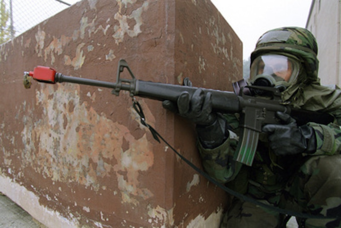 An airman from the 51st Communications Squadron, Osan Air Base, Korea, mans his post at Building 949 as a Security Protection Team member during a simulated attack by opposition forces on Oct. 26, 1999, as part of Exercise Foal Eagle '99. Foal Eagle '99 is the 38th in a series of regularly scheduled rear area defense field training exercises. The annual exercise is held at a variety of locations throughout the Korean peninsula and involves some 30,000 U.S. military forces. 