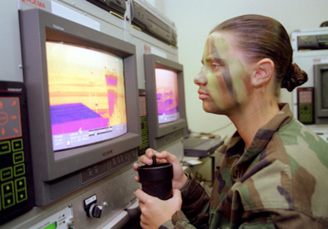 Airman First Class Olivia Latham uses a Wide Angle Surveillance Thermal Imager to scan the control tower at Osan Air Base, Korea, for infiltrators during Exercise Foal Eagle '99 on Oct. 27, 1999. Exercise Foal Eagle '99 is the 38th in a series of regularly scheduled rear area defense field training exercises. The annual exercise is held at a variety of locations throughout the Korean peninsula and involves some 30,000 U.S. military forces. Latham is attached to the 51st Security Forces Squadron at Osan. 