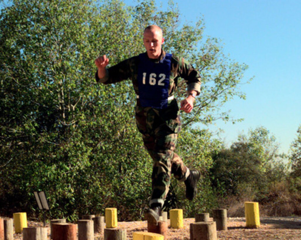 Air Force Material Command Senior Airman Bret A. Hodgson leaps his way through the Island Hopper, one of the 21 obstacles in the fitness competition during Defender Challenge '99 at Lackland Air Force Base, Texas, on Nov. 1, 1999. Defender Challenge is an all-star competition featuring Security Forces from Air Force major commands and the Royal Air Force Regiment. Teams compete in a fitness challenge, handgun events, combat rifle, combat weapons and nighttime tactical events. 