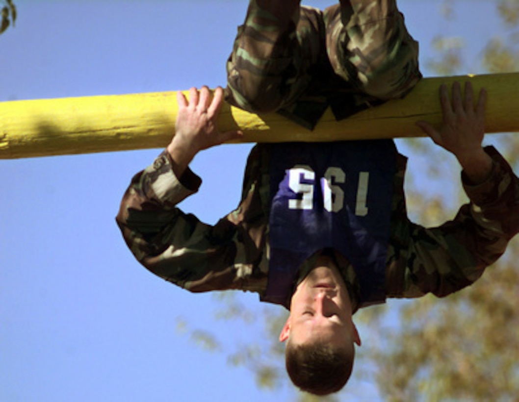 Air Combat Command Team member Airman 1st Class Justin D. Johnston flips over The Dirty Name obstacle during the fitness challenge event of Defender Challenge '99 at Lackland Air Force Base, Texas, on Nov. 1, 1999. Defender Challenge is an all-star competition featuring Security Forces from Air Force major commands and the Royal Air Force Regiment. Teams compete in a fitness challenge, handgun events, combat rifle, combat weapons and nighttime tactical events. 