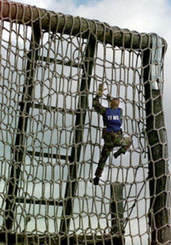 Senior Airman Eric Sawyer of the 11th Wing Team scales the net of the first of 21 obstacles of the Chief's Challenge during Defender Challenge '99 at Lackland Air Force Base, Texas, on Nov. 6, 1999. Defender Challenge is an all-star competition featuring Security Forces from Air Force major commands and the Royal Air Force Regiment. Teams compete in a fitness challenge, handgun events, combat rifle, combat weapons and nighttime tactical events. The Chief's Challenge, a head-to-head competition on the obstacle course, is the only individual event in Defender Challenge. 