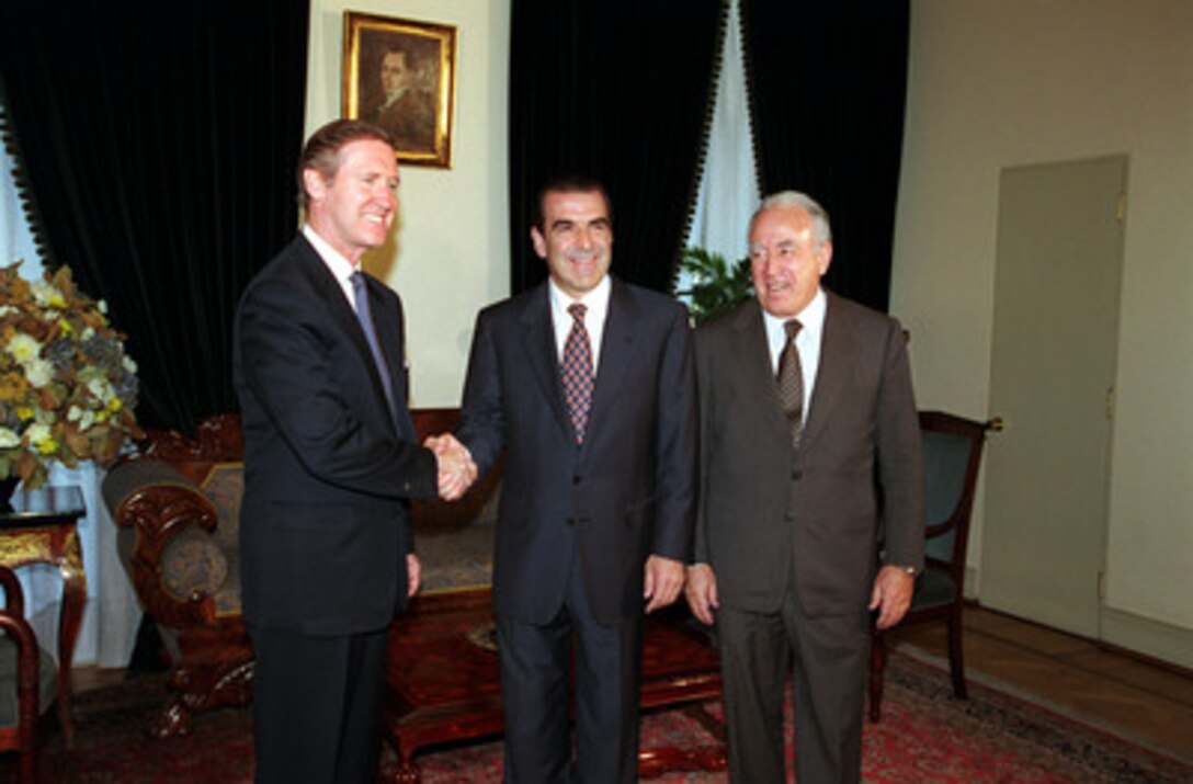 Secretary of Defense William S. Cohen (left) is welcomed to La Moneda by President Eduardo Frei Ruiz-Tagle (center) and Minister of Defense Edmundo Perez Yoma (right) in Santiago, Chile on Nov. 16, 1999. Cohen is in Santiago to meet with defense officials and discuss issues of interest to both nations. 