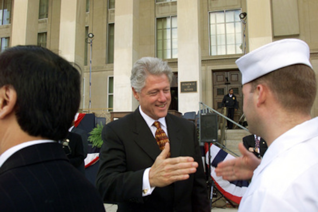 President Bill Clinton reaches for the hand of a sailor as he shakes hands with U.S. service members and DoD employees at the Pentagon after signing the National Defense Authorization Act FY 2000 on Oct. 5, 1999. The Act provides for the first sustained increase in defense spending in 15 years and reflects the imperative of providing a sound quality of life for our uniformed people. Service men and women will see a 4.8 percent pay increase starting Jan. 1, 2000. 