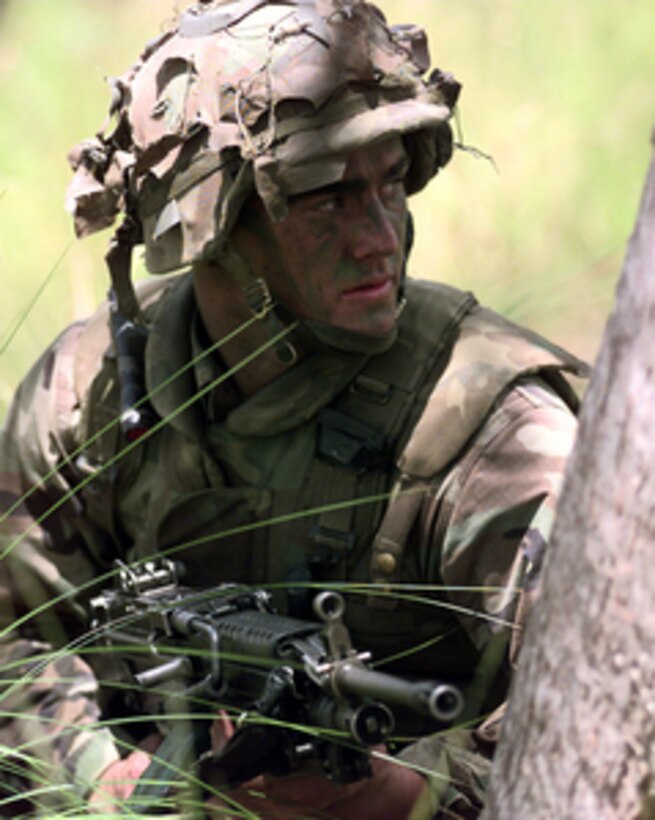 Pfc. Joe Gould, U.S. Marine Corps, looks for aggressor targets during a live fire exercise at the Shoalwater Bay Training Area in Queensland, Australia, on Oct. 3, 1999, as part of Exercise Crocodile '99. Exercise Crocodile '99 is a combined U.S. and Australian military training exercise. Gould is attached to Battalion Landing Team 15, Bravo Company. 