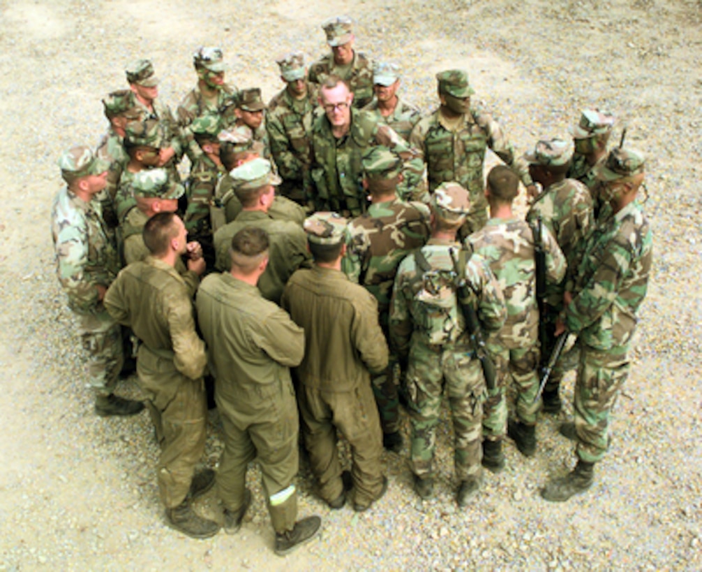 U.S. Marine Lt. Col. Pat Garrett (center) debriefs tank and Amphibious Assault Vehicle drivers gathered around him after a live fire exercise at the Shoalwater Bay Training Area in Queensland, Australia, on Oct. 3, 1999, as part of Exercise Crocodile '99. Exercise Crocodile '99 is a combined U.S. and Australian military training exercise. Garrett is attached to Battalion Landing Team 15. 