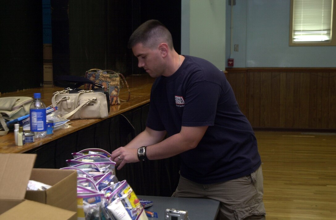 JACKSONVILLE, N.C. - Tech. Sgt. David E. Allshouse Jr., a CV-22 Osprey electronic environmental instructor stacks plastic bags full of supplies at the United Service Organization here June 9. More than thirty volunteers arrived to help pack more than 300 bags with an assortment of hygiene products including toothbrushes, toothpaste and razors. (Official U.S. Marine Corps photo by Lance Cpl. Brandon R. Holgersen)