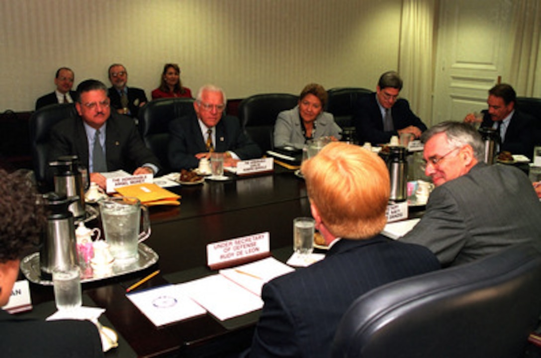 Members of the Puerto Rican Governor's Working Group on Vieques including Angel Morey (left), Carlos Romero Barcelo (center), Manuela Santiago (third from right), Carlos Pesquera (second from right), and Fernando Martin (right) meet in the Pentagon with Under Secretary of Defense Rudy DeLeon (foreground) and Secretary of the Navy Richard Danzig (right foreground) on Sept. 13, 1999. 