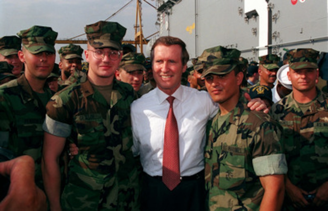 Secretary of Defense William S. Cohen poses for a photograph with U.S. Marines of the 26th Marine Expeditionary Unit aboard the USS Kearsarge (LHD 3) in port at Thessaloniki, Greece, on July 13, 1999. Marines of the 26th Marine Expeditionary Unit were among the first U.S. troops to enter Kosovo following the cease fire agreement reached with the Yugoslav Government. 
