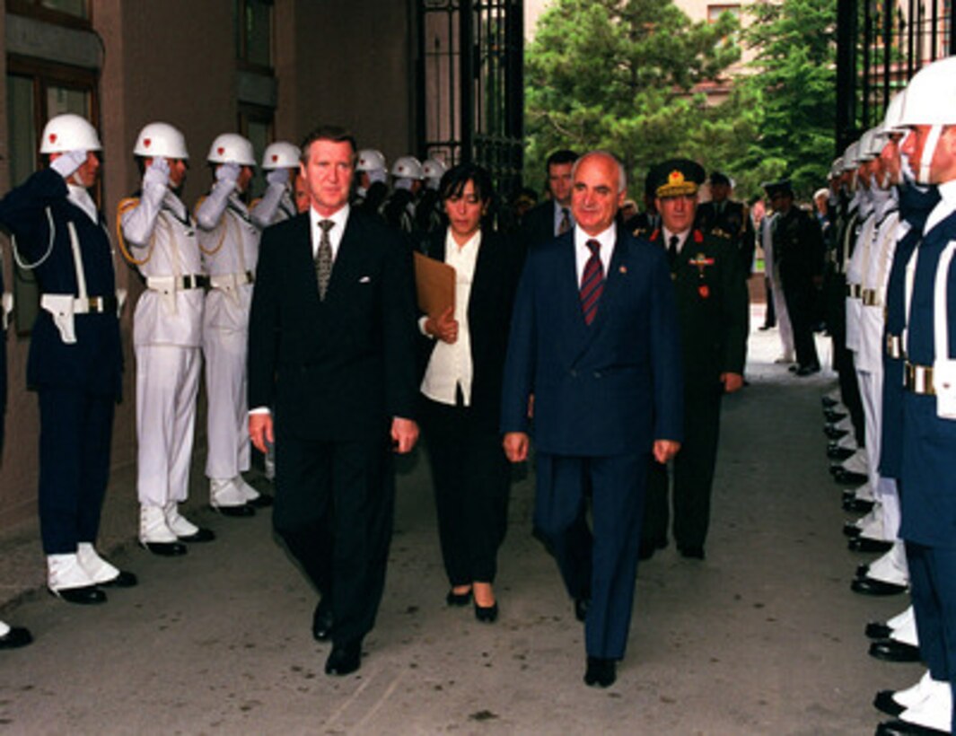 Secretary of Defense William S. Cohen (left) is escorted through an honor cordon by Turkish Defense Minister Sabahattin Cakmakoglu (right) as he arrives at the Defense Ministry in Ankara, Turkey, on July 15, 1999. 