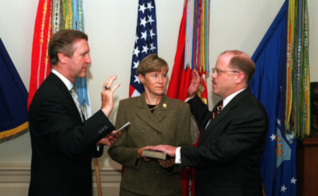 F. Whitten Peters (right) is administered the oath of office as the 19th Secretary of the Air Force by Secretary of Defense William S. Cohen (left) as Peters' wife Mary G. "Monnie" Peters (center) holds the Bible in a Pentagon ceremony on Sept. 8, 1999. 