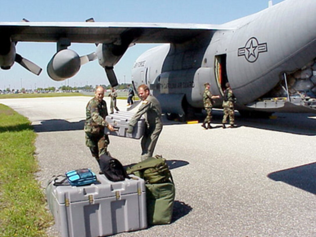 North Carolina Air National Guard airmen off load medical supplies from a C-130 Hercules transport aircraft delivering troops and relief supplies to Wilmington International Airport, N.C. on Sept. 17, 1999. The airmen are joining hundreds of other National Guard troops in North Carolina and surrounding states to provide disaster and humanitarian relief for thousands of people hit by Hurricane Floyd. The airmen are attached to the 156th Air Evacuation Squadron, Charlotte, N.C. The Hercules is attached to the North Carolina Air National Guard's 145th Airlift Wing. 