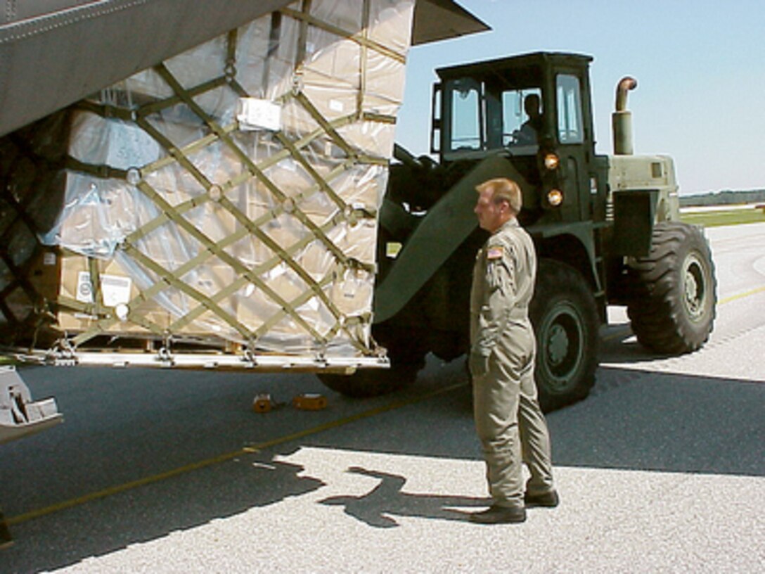 North Carolina Air National Guard Master Sgt. Gene Dellinger directs a forklift operator as they unload a pallet of relief supplies from a C-130 Hercules at Wilmington International Airport, N.C. on Sept. 17, 1999. The airmen are joining hundreds of other National Guard troops in North Carolina and surrounding states to provide disaster and humanitarian relief for thousands of people hit by Hurricane Floyd. Dellinger, of Indian Head, S.C., is a loadmaster with the 145th Airlift Wing in Charlotte, N.C. The Hercules is attached to the North Carolina Air National Guard's 145th Airlift Wing. 