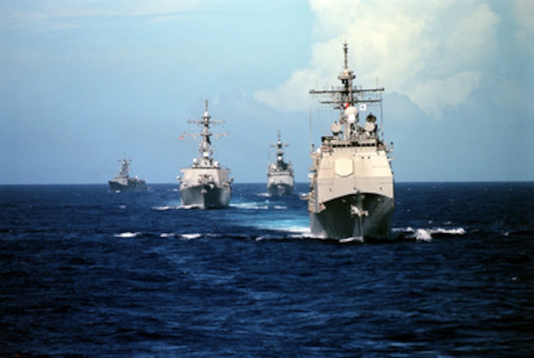 The Ticonderoga Class Guided Missile Cruiser USS Vincennes (CG 49) (right) steams in front of three other classes of U.S. Navy ships as they operate in the Pacific Ocean during a Y2K operational testing exercise on Sept. 18, 1999. Following the Vincennes from right to left are the Spruance Class Destroyer USS John Cushing (DD 985), Arleigh Burke Class Guided Missile Destroyer USS John S. McCain (DDG 56), and the Oliver Hazard Perry class Guided Missile Frigate USS Gary (FFG 51). 