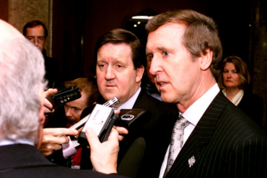 Secretary of Defense William S. Cohen (right) and British Defense Minister George Robertson (left) talk with reporters following their breakfast meeting at the annual Autumn Informal Meeting of NATO Defense Ministers in Toronto, Canada, on Sept. 21, 1999. Robertson will soon succeed Javier Solana of Spain as the Secretary General of NATO. 