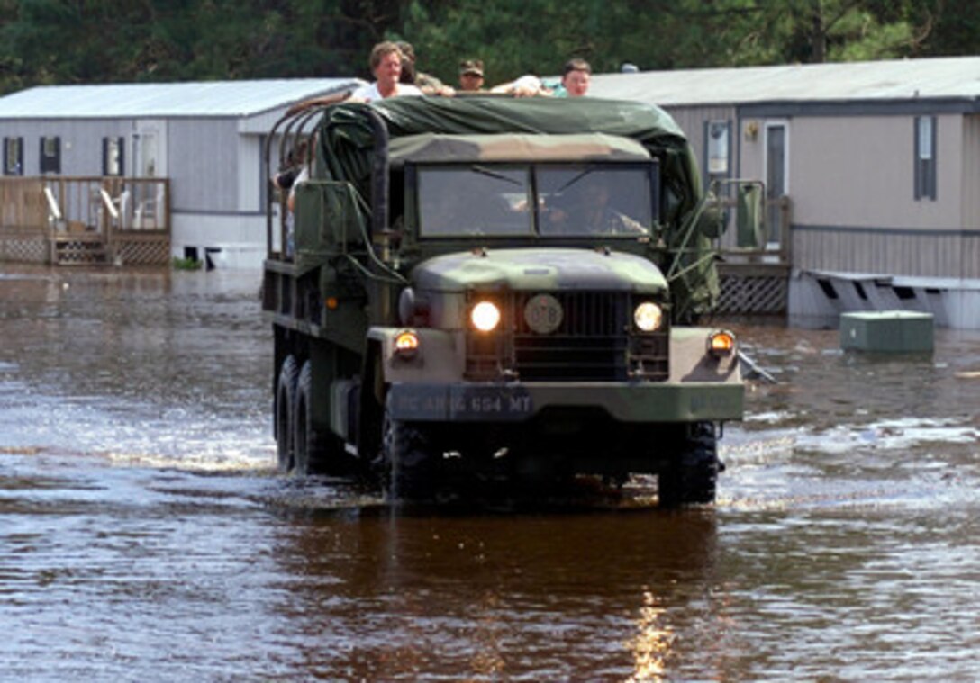 A North Carolina National Guard 5-ton truck from the 694th Transportation Company evacuates residents from a trailer park near Greenville, N.C., on Sept. 19, 1999, after flood waters caused by Hurricane Floyd forced them from their homes. Hundreds of National Guard troops in North Carolina and surrounding states been called on state active duty to provide disaster and humanitarian relief for thousands of people hit by Hurricane Floyd. 