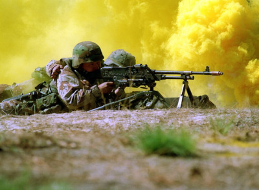 Lance Cpl. Keven A. Jones lays down cover fire for advancing troops during a field exercise at Fort Bragg, N.C., on March 13, 2000. Jones, from Palatine, Ill., is attached to the 3rd Battalion, 8th Marines. 
