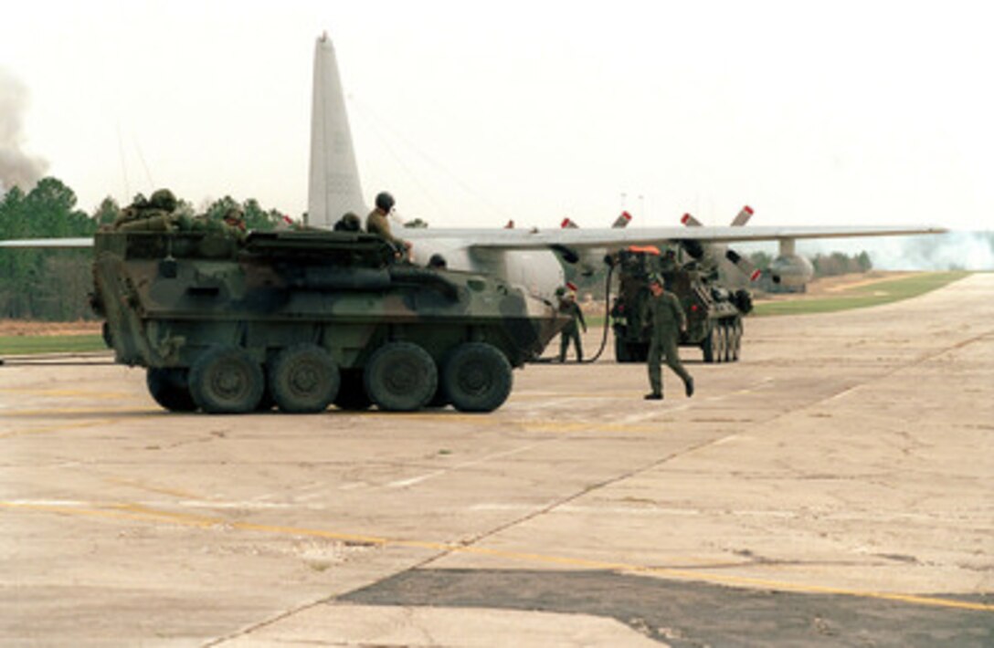 U.S. Marines from the Light Armored Reconnaissance Battalion refuel their light armored vehicles from a C-130 Hercules aircraft at the Expeditionary Air Field Fort Bragg, N.C., on March 11, 2000. Marines from the 2nd Marine Division are participating in routine field exercise at Fort Bragg. 