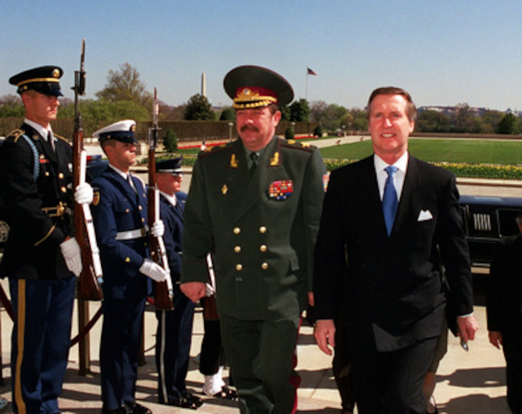 Secretary of Defense William S. Cohen (right) escorts Minister of Defense Oleksandr Kuzmuk (left), of Ukraine, through an honor cordon and into the Pentagon on March 31, 2000. The two leaders and their senior advisors will meet to discuss a range of regional security issues of interest to both nations. 
