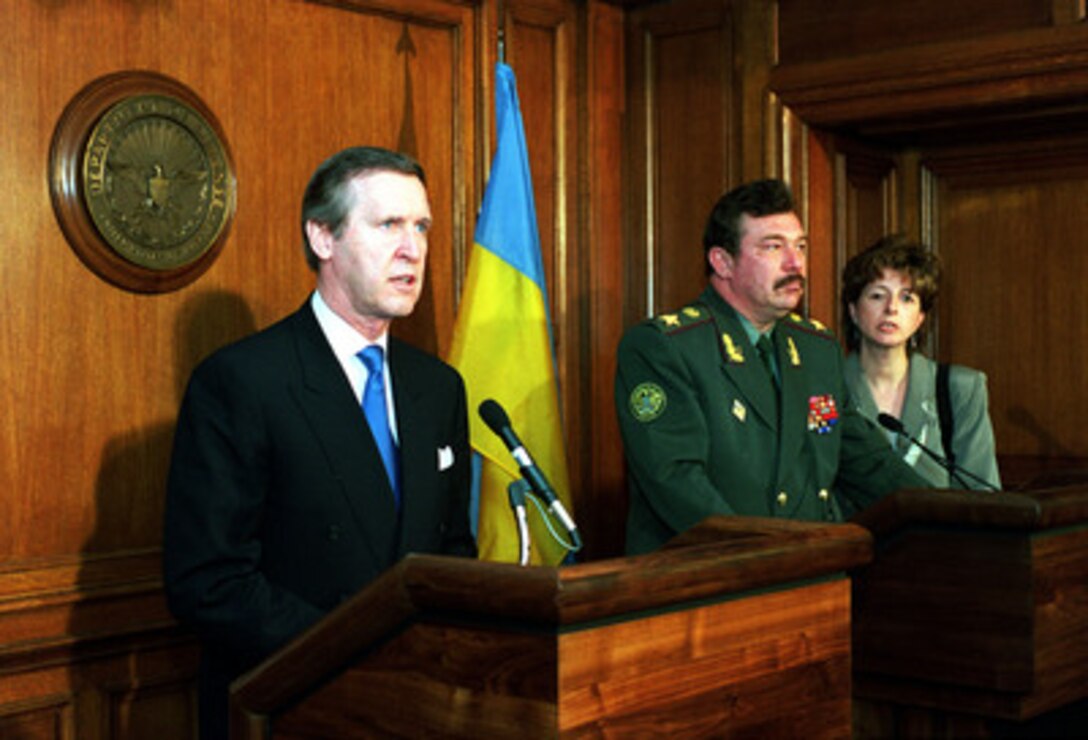 Secretary of Defense William S. Cohen (left) responds to a reporter's question while Minister of Defense Oleksandr Kuzmuk (right), of Ukraine, listens to the interpreter. The two leaders conducted a joint press briefing at the Pentagon on March 31, 2000, following their meeting. 