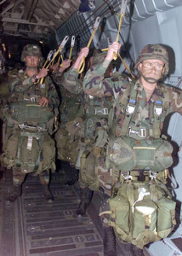 Maj. Gen. Dan K. McNeill, Commanding General of the 82nd Airborne, approaches the troop carrier door of a C-141B Starlifter to lead his troops for an aerial assault onto the drop zone on Ft Polk, La. The exercise, called Large Package Week, on April 5, 2000, involves the airdropping of 1200 paratroopers from the 82nd Airborne and their heavy equipment onto the drop zone. Large Package Week is a quarterly training exercise designed to build cohesiveness between the 82nd Airborne and Air Mobility Command units. 