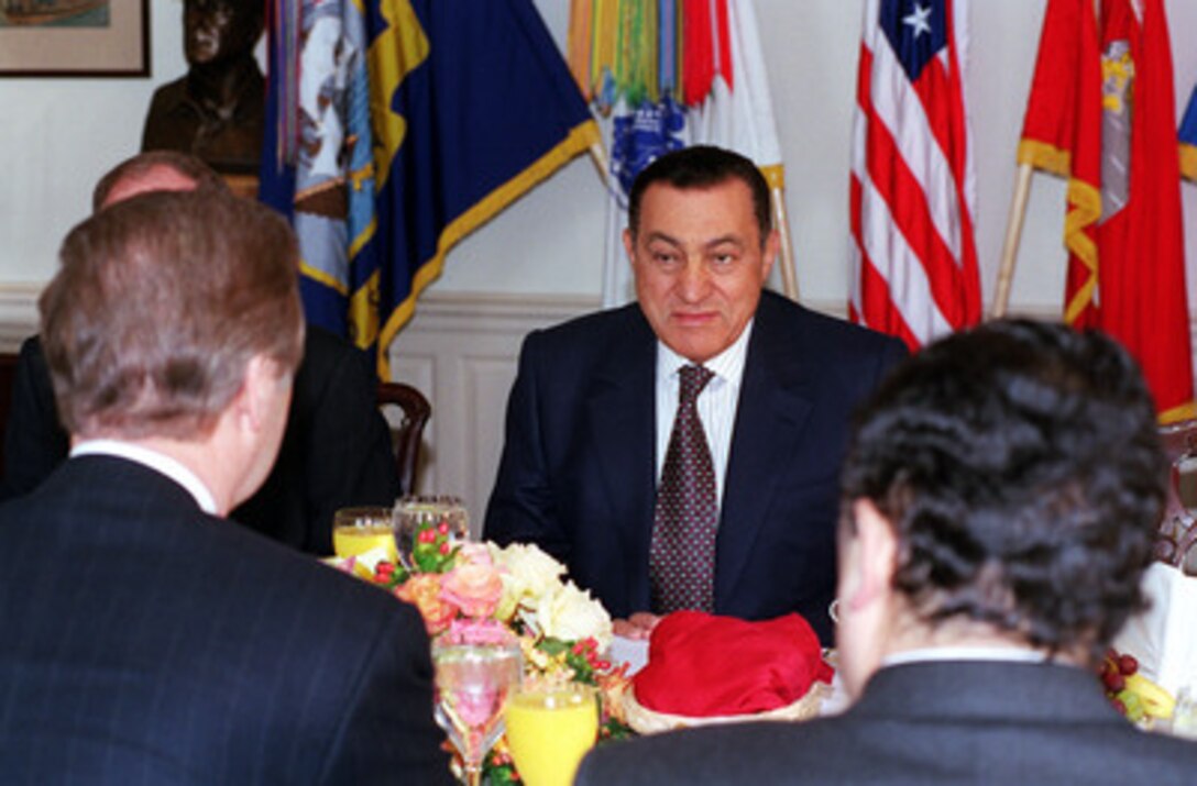 Secretary of Defense William S. Cohen (left foreground) hosts a working breakfast with visiting Egyptian President Hosni Mubarak (center) at the Pentagon, March 30, 2000. Under discussion were a broad range of regional security issues. 