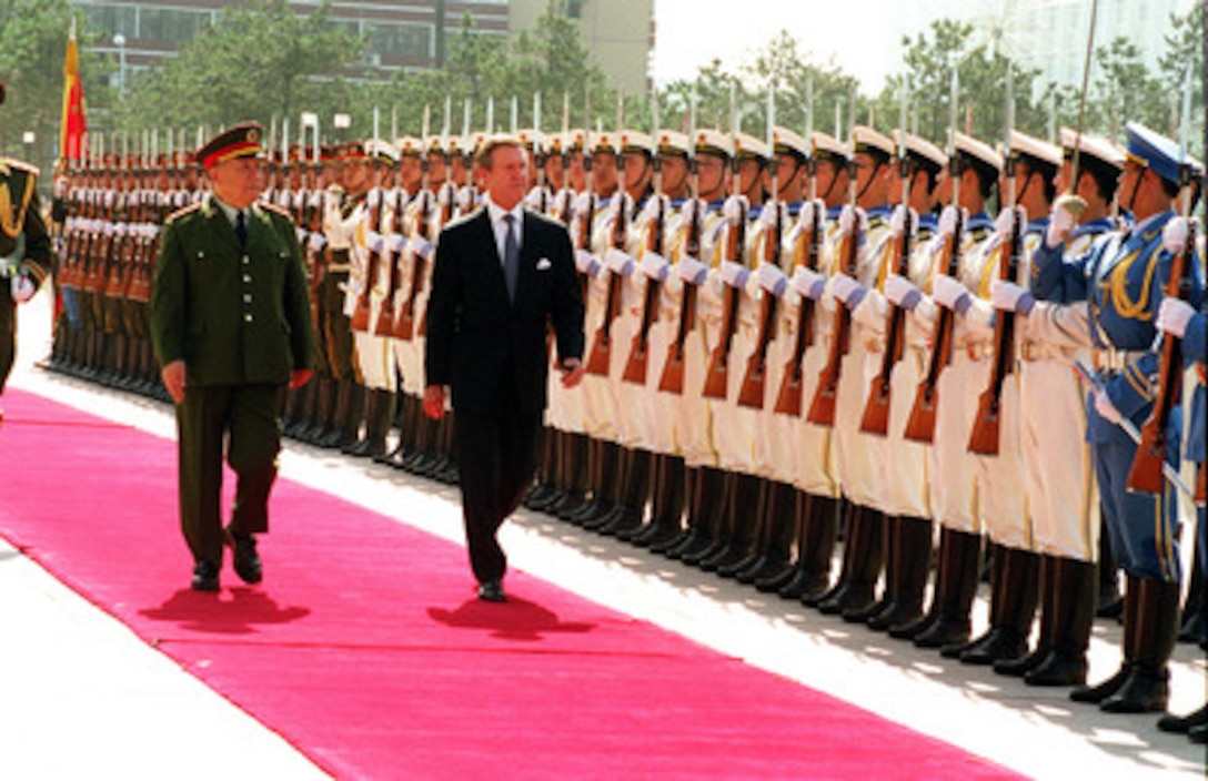 Minister of National Defense Gen. Chi Haotian (left) escorts Secretary of Defense William S. Cohen (right) as he inspects the troops during an armed forces welcoming ceremony at the Ministry of National Defense Headquarters in Beijing, China, on July 12, 2000. Cohen is visiting Beijing, Shanghai and Sydney, Australia as part of a seven day trip to the Western Pacific. 