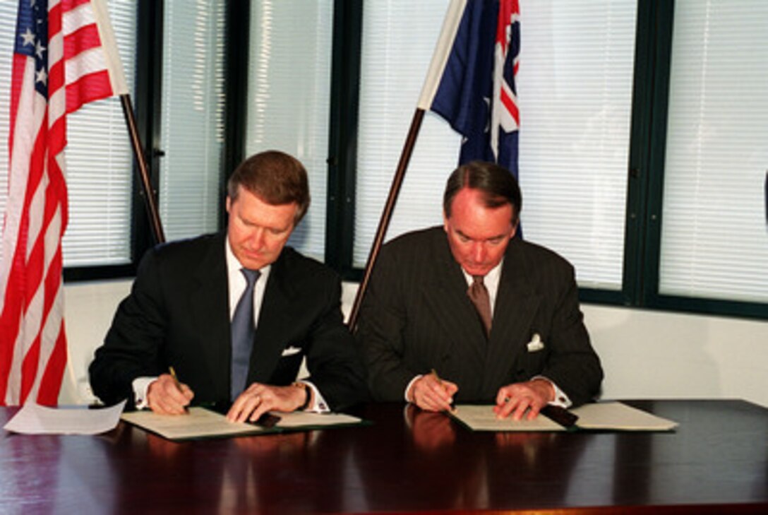 Secretary of Defense William S. Cohen (left) and Defense Minister John Moore (right) sign a Statement of Principles at the Maritime Headquarters at Potts Point in Sydney, Australia, on July 17, 2000. The statement establishes further mutual cooperation in a broad range of defense issues. Cohen is visiting Sydney to meet with government and civic leaders during a seven day trip to the Western Pacific. 