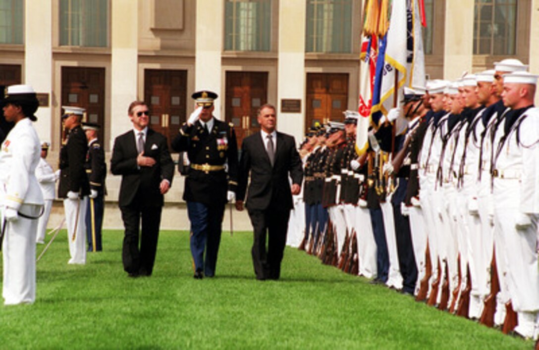 Swiss President and Minister of Defense Adolf Ogi (right) is escorted by Col. Thomas M. Jordan (center), U.S. Army, and Secretary of Defense William S. Cohen (left), as he inspects the troops during a Pentagon armed forces full honors arrival ceremony on July 28, 2000. Cohen and Ogi will meet to discuss security issues of interest to both nations. 