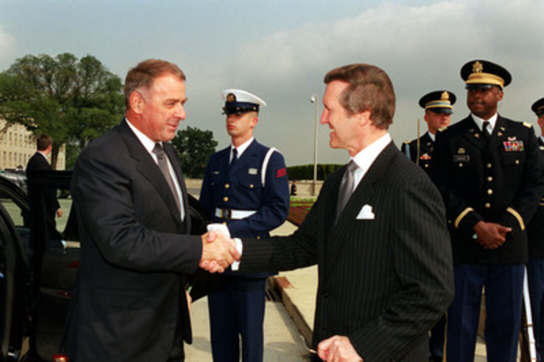 President and Minister of Defense Adolf Ogi (left), of Switzerland, is greeted by Secretary of Defense William S. Cohen (right) as he arrives at the Pentagon for an armed forces full honors arrival ceremony on July 28, 2000. Cohen and Ogi will meet to discuss security issues of interest to both nations. 