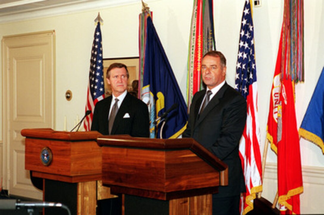 Swiss President and Minister of Defense Adolf Ogi (right) responds to a reporter's question during a joint press conference with Secretary of Defense William S. Cohen at the Pentagon on July 28, 2000. Ogi and Cohen met to discuss security issues of interest to both nations. 