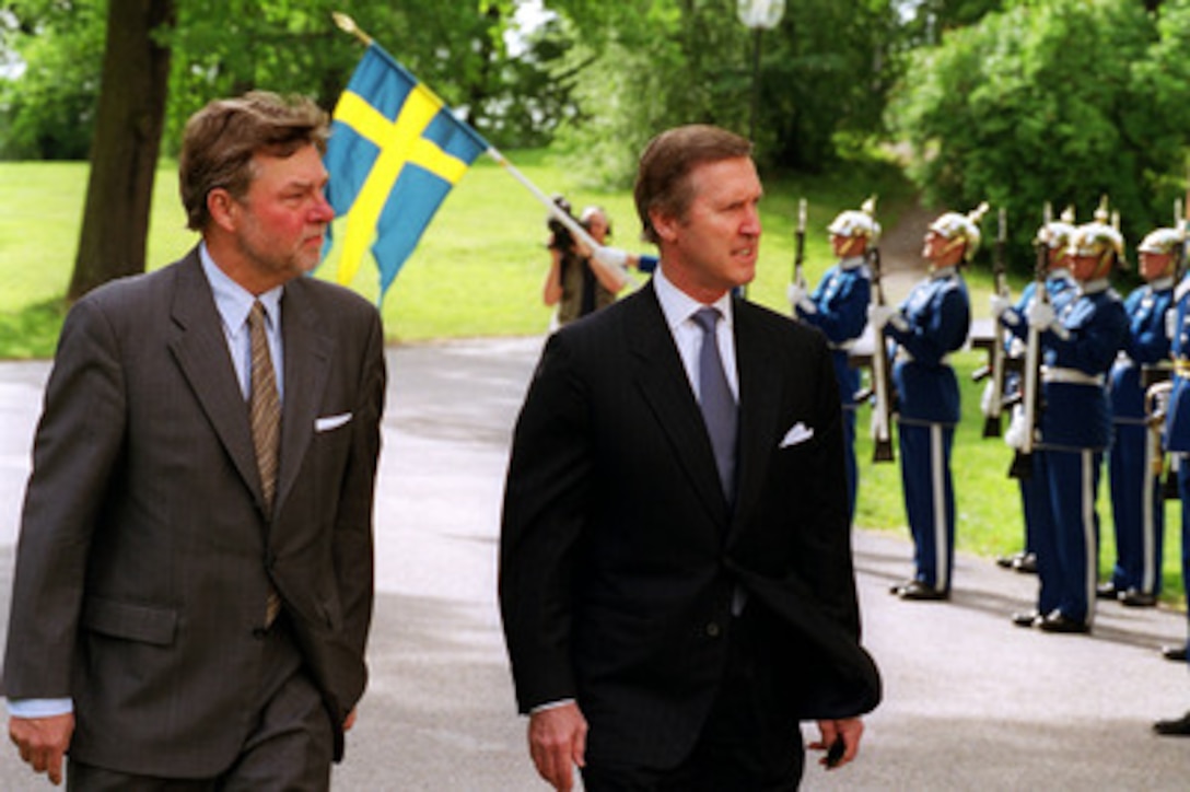Secretary of Defense William S. Cohen (right) inspects the honor guard at Haga Palace in Stockholm, Sweden, during a military welcoming ceremony hosted in his honor by Swedish Minister of Defense Bjorn Von Sydow (left) on June 12, 2000. Cohen will meet with Von Sydow to discuss a range of security issues of mutual interest to both nations. 