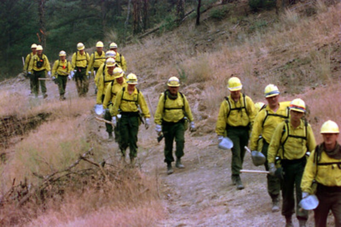 Soldiers from Company B, 1st Battalion, 163rd Mechanized Infantry, Montana Army National Guard return to their drop point following a day of fighting the Cave Gulch Fire located near Canyon Ferry, Mont. on Aug. 2, 2000. More than 2,300 servicemembers from the Army, Marines, Air and Army Guard and Air Force Reserve are conducting firefighting and support operations for the Western wildfires in response to requests from the National Interagency Firefighting Center in Boise, Idaho, and as directed by the governors of several states. 