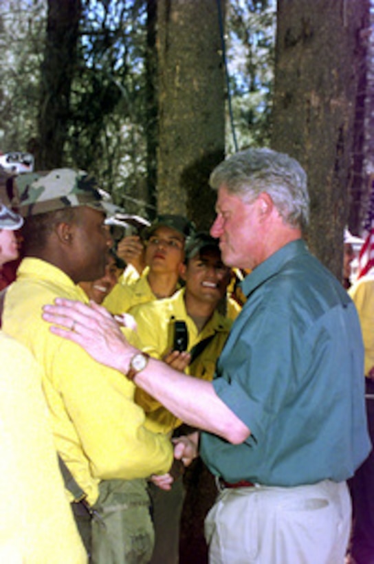 President Bill Clinton shakes hands and talks with soldiers from the Army's 3rd Battalion, 16th Field Artillery Regiment who are on fire fighting duty near Burgdorf Junction, Idaho, on Aug. 8, 2000. More than 2,300 servicemembers from the Army, Marines, Air and Army Guard and Air Force Reserve are conducting firefighting and support operations for the Western wildfires in response to requests from the National Interagency Firefighting Center in Boise, Idaho, and as directed by the governors of several states. 