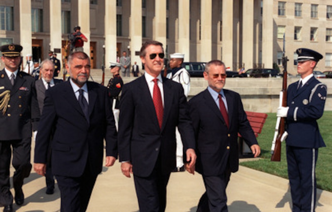 Croatian President Stjepan Mesic (left) and Prime Minister Ivica Racan (right) are escorted by Secretary of Defense William S. Cohen (center) to the Pentagon River Parade Field for an armed forces full honors arrival ceremony on Aug. 8, 2000. Mesic, Racan and Cohen will later meet to discuss general regional security issues of interest to both nations. 