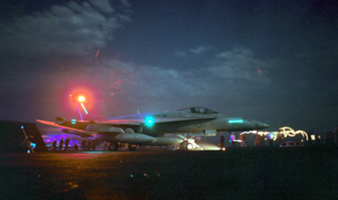 An F/A-18C Hornet is prepared for a night catapult launch from the flight deck of the aircraft carrier USS George Washington (CVN 73) while the ship conducts flight operations in the Persian Gulf on Aug. 11, 2000. Washington and its embarked Carrier Air Wing 17 are on station in the Persian Gulf in support of Operation Southern Watch, which is the U.S. and coalition enforcement of the no-fly-zone over Southern Iraq. The Hornet is attached to Strike Fighter Squadron 34 of Oceana Naval Air Station, Va. The Washington is deployed from its home port of Norfolk, Va. 