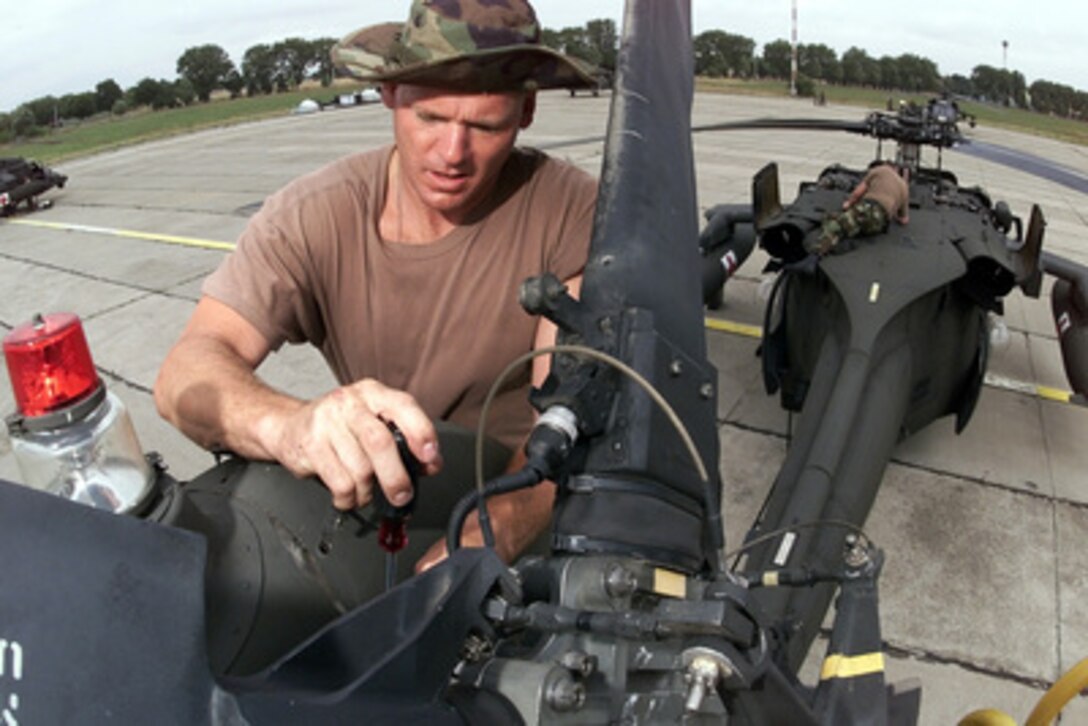 Army National Guard Staff Sgt. David Nash conducts maintenance on the tail rotor of a UH-60Q Black Hawk medevac helicopter at Constanta, Romania, on July 13, 2000, during Exercise Rescue Eagle 2000. Rescue Eagle 2000, is a Romanian-hosted joint and combined exercise designed to improve the abilities of multi-national forces to conduct peacekeeping, search and rescue, humanitarian assistance and disaster relief missions. Forces from Azerbaijan, Bulgaria, Georgia, France, Germany, Greece, Hungary, Italy Moldovia, Romania, Slovakia, Turkey and the United States are participating in the exercise. Nash is from Jackson, Tenn. The Black Hawk is assigned to the Combat Enhanced Capability Aviation Team (Medical), Tennessee Army National Guard, Knoxville, Tennessee. 