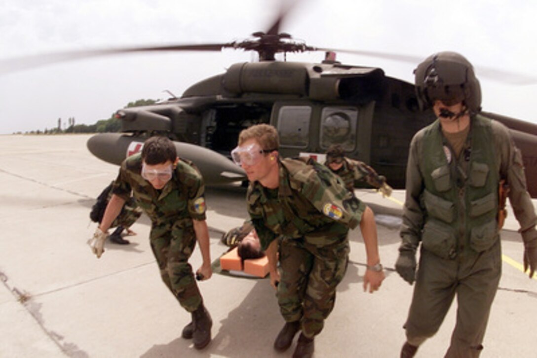 Multi-national litter bearers unload a simulated patient off a UH-60Q Black Hawk medevac helicopter at Constanta, Romania, on July 13, 2000, during Exercise Rescue Eagle 2000. Rescue Eagle 2000 is a Romanian-hosted joint and combined exercise designed to improve the abilities of multi-national forces to conduct peacekeeping, search and rescue, humanitarian assistance and disaster relief missions. Forces from Azerbaijan, Bulgaria, Georgia, France, Germany, Greece, Hungary, Italy Moldovia, Romania, Slovakia, Turkey and the United States are participating in the exercise. The Black Hawk is assigned to the Combat Enhanced Capability Aviation Team (Medical), Tennessee Army National Guard, Knoxville, Tennessee. 