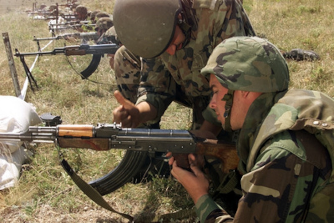 U.S. Marine Cpl. Chris P. Duane (right) receives assistance from an Romanian soldier in clearing a Russian RPK squad automatic rifle during the weapons familiarization phase of Exercise Rescue Eagle 2000 at Babadag Range, Romania, on July 15, 2000. Rescue Eagle 2000 is a Romanian-hosted joint and combined exercise designed to improve the abilities of multi-national forces to conduct peacekeeping, search and rescue, humanitarian assistance and disaster relief missions. Forces from Azerbaijan, Bulgaria, Georgia, France, Germany, Greece, Hungary, Italy Moldovia, Romania, Slovakia, Turkey and the United States are participating in the exercise. Duane, from Morristown, N.J., is attached to Golf Company, 25th Marine Regiment. 