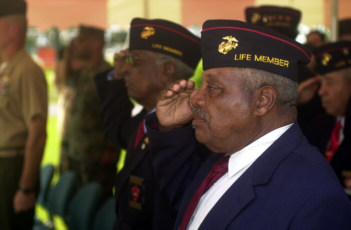 MARINE CORPS BASE CAMP LEJEUNE, N.C. - Paul Haygan, member of the Montfort Point Marine Association, salute while the national anthem is played here June 23 during the 64th Camp Johnson Rededication Wreath Laying ceremony here. The associations gather every year in June to honor the 2,000 African American Marines who overcame adversity and fought to have the right to fight for their country. The idea of the wreath ceremony was to bring all the Montfort Point Marines back together to where they came from and also to honor the Marines that gave the ultimate sacrifice in battle and others who have passed away since (Official U.S. Marine Corps photo by Lance Cpl. Brandon R. Holgersen)(released)