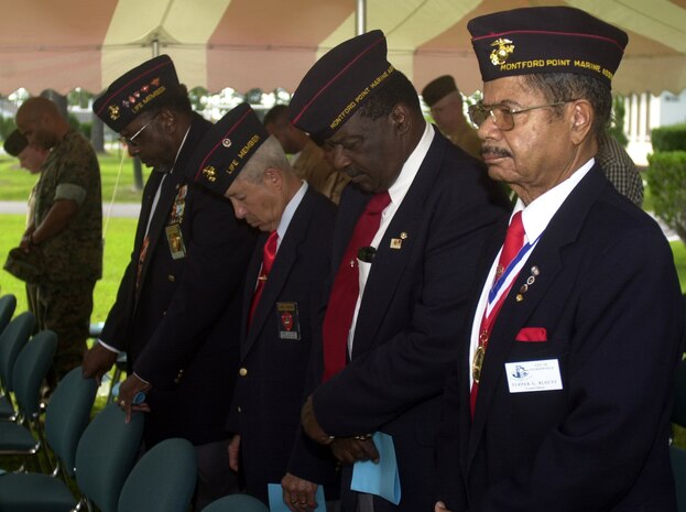 MARINE CORPS BASE CAMP LEJEUNE, N.C. - Turner Blount, city councilman,(right) and other Montfort Point Marines bow their heads while the invocation is given during the 64th Camp Johnson Rededication Wreath Laying ceremony here June 23. The Montfort Point Marines Association and the Montfort Point Marines Women's Auxiliary Association gather every year in June to honor the 2,000 African American Marines who overcame adversity and fought to have the right to fight for their country.    (Official U.S. Marine Corps photo by Lance Cpl. Brandon R. Holgersen)(released)